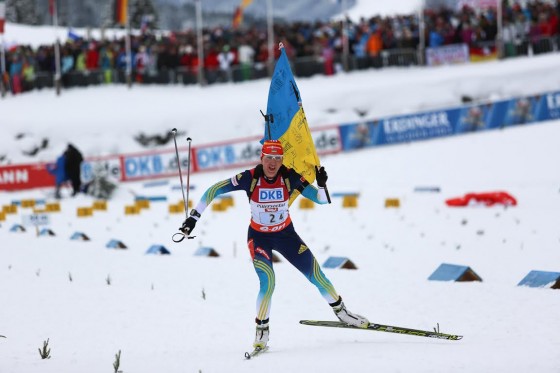 Олена Підгрушна фінішує з прапором українських уболівальників біатлону.
